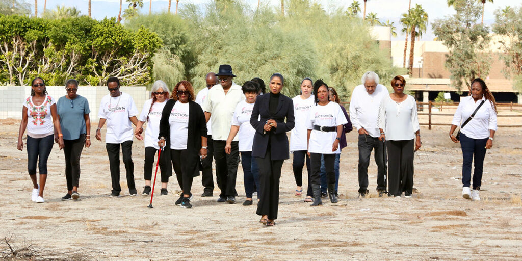 Survivors of Section 14 walk on the land that once held their homes.