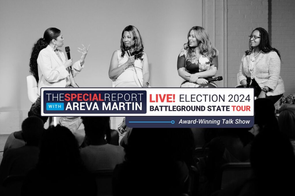 Areva on stage with a panel of three women